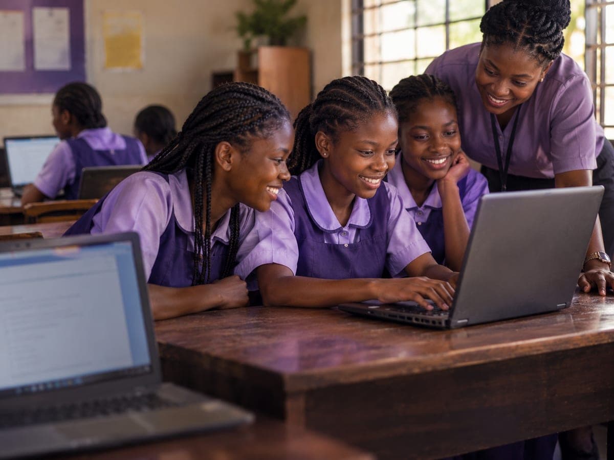 A mentor and a girl beside new laptops