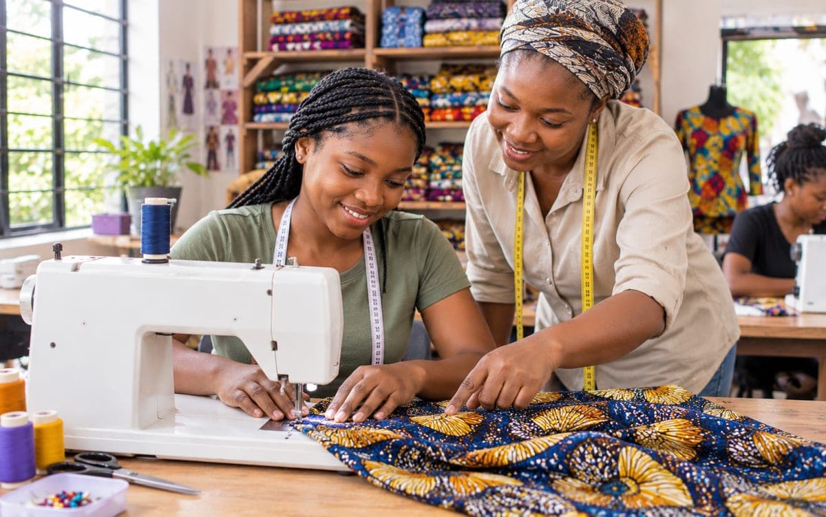 A woman learning to sew at a JTAH skills session