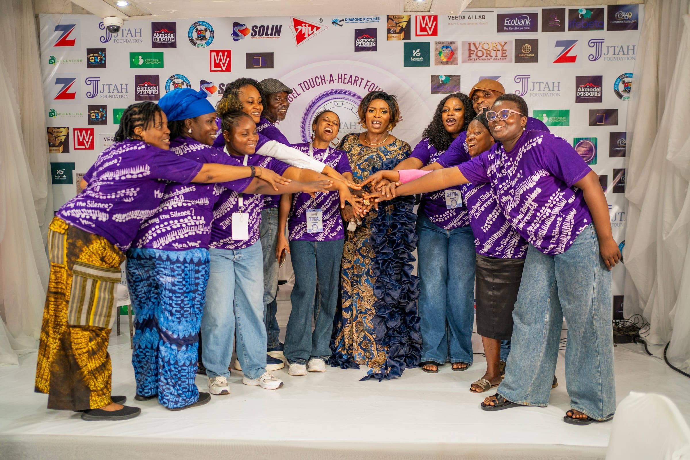 JTAH Foundation team members joining hands with the founder at an event
